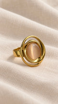 Solenne Ring gold oval blush pink stone close-up on linen