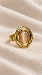 Solenne Ring gold oval blush pink stone close-up on linen