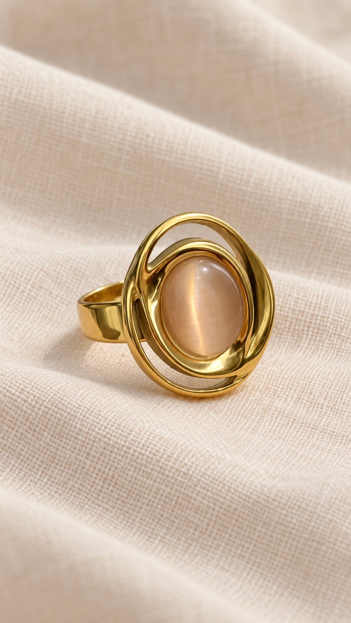 Solenne Ring gold oval blush pink stone close-up on linen