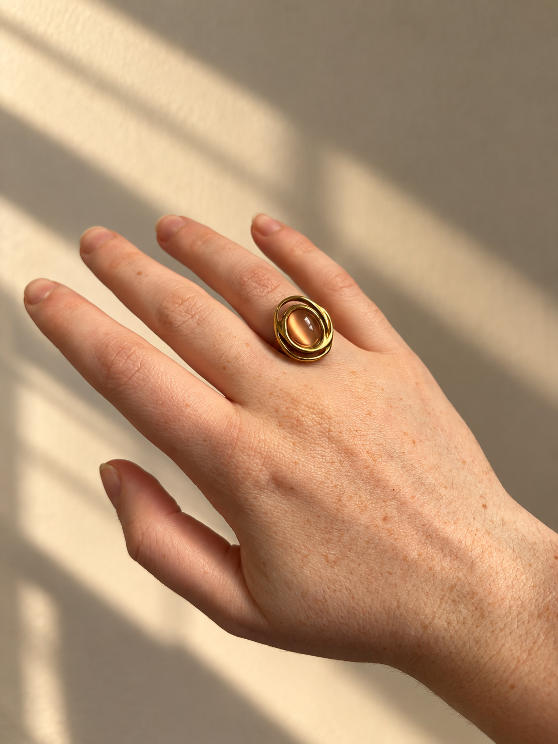Solenne Ring gold pink oval stone worn on hand
