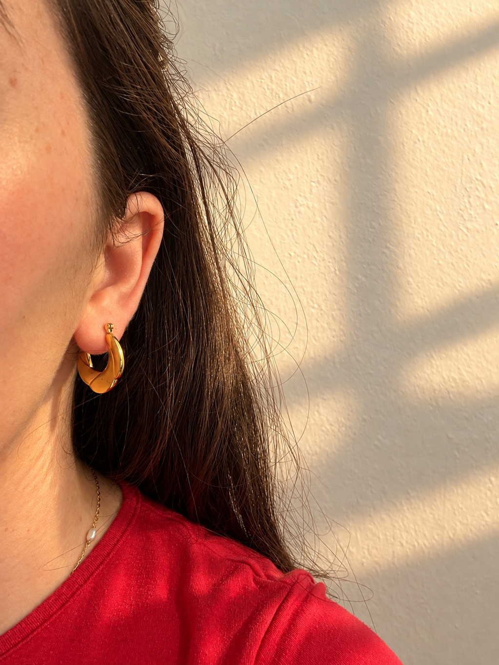 Tressa Earrings – gold twisted hoop earrings worn